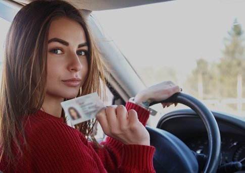Girl showing their driving licence