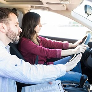 Driving instructor teaching about the car