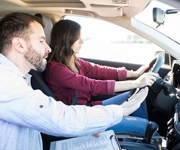 Driving instructor teaching about the car