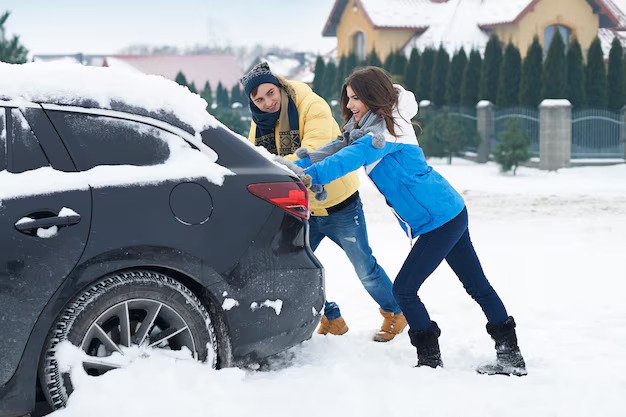 Couple Pushing Car stucked in Snow