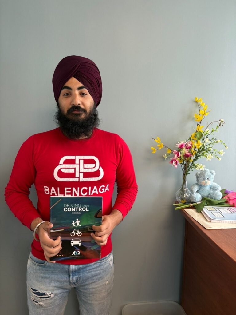 New driver showing off driving license success at Unity Driving School
