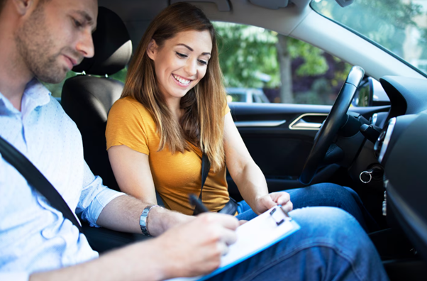 Driving instructor and student in car lesson 